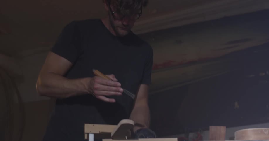 Carpenter Making Guitar In Workshop