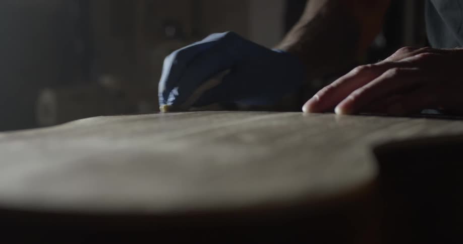 A person is using a sponge on a guitar
