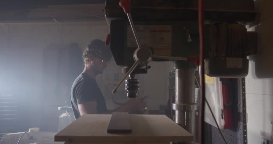 Carpenter Making Guitar In Workshop