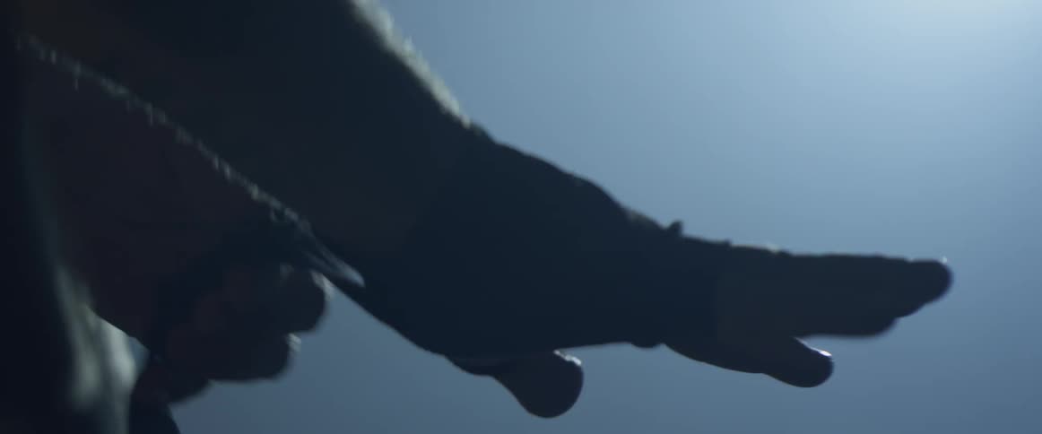 A man is tying rope around his hands