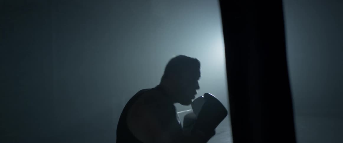 A man is boxing indoors