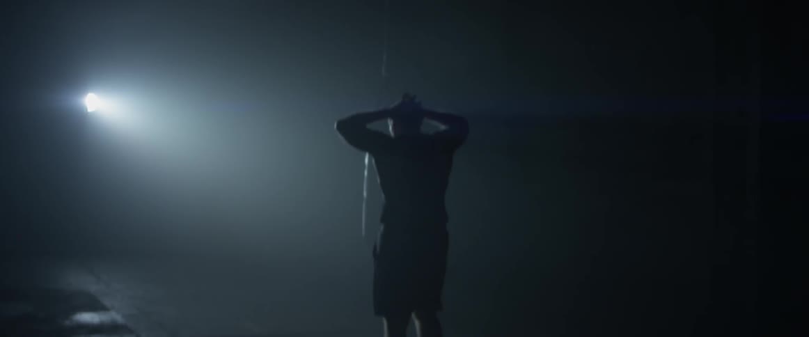 Backlit man jumps rope in slow motion