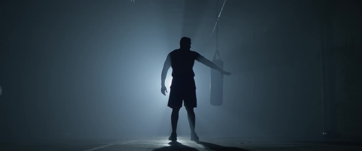 A man throws his boxing gloves