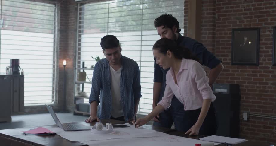 Three people are talking about different plans using electronics