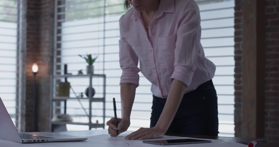 A woman is writing at a table