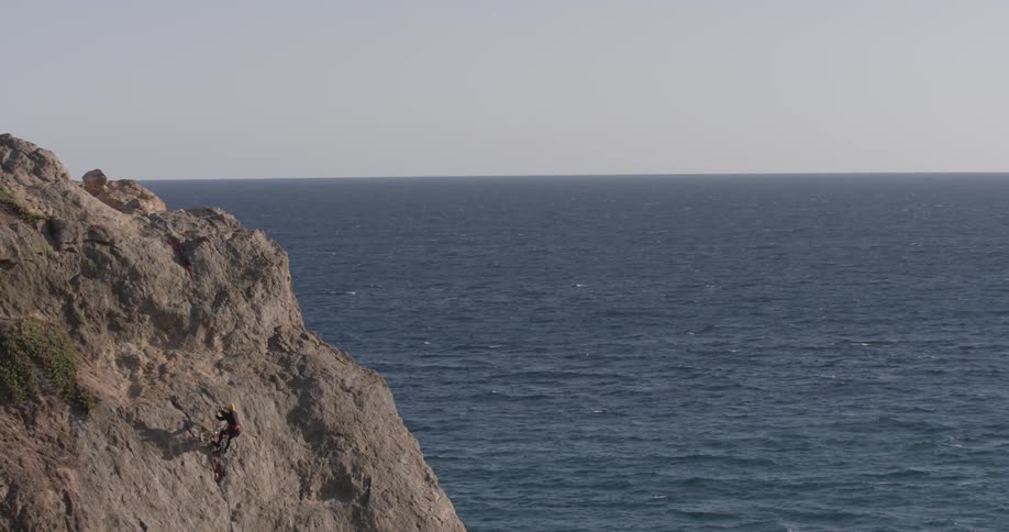 Man Climbing Wall By The Beach