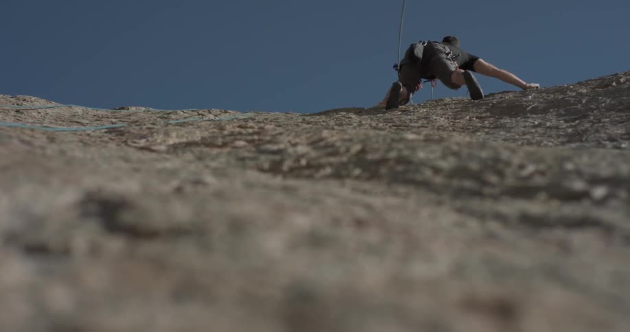 Man Climbing Wall By The Beach