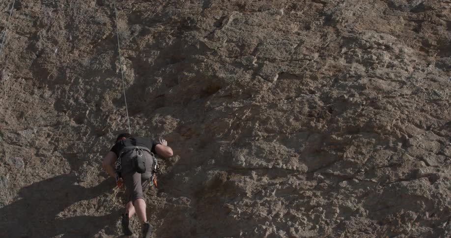 Man Climbing Wall By The Beach
