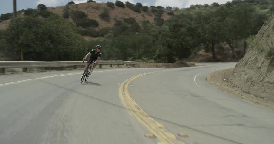 A man riding down a mountain on a bicycle