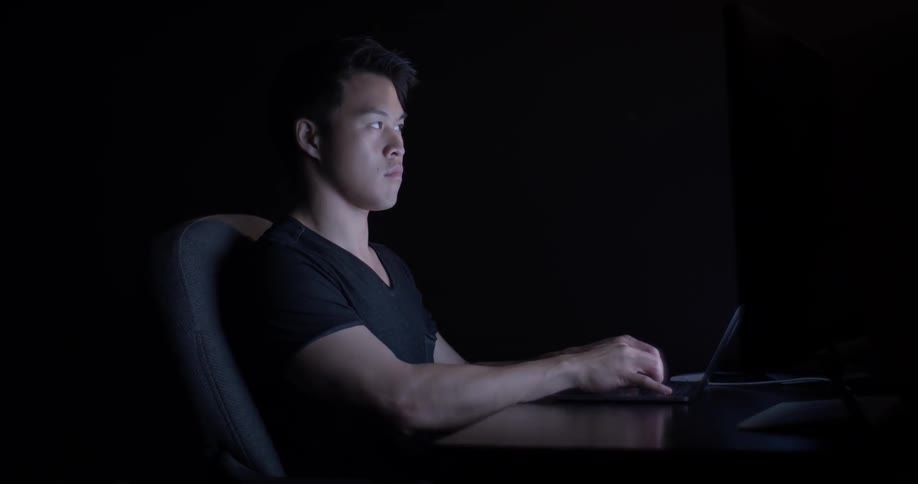 Man Coding On Computer In Dark Room