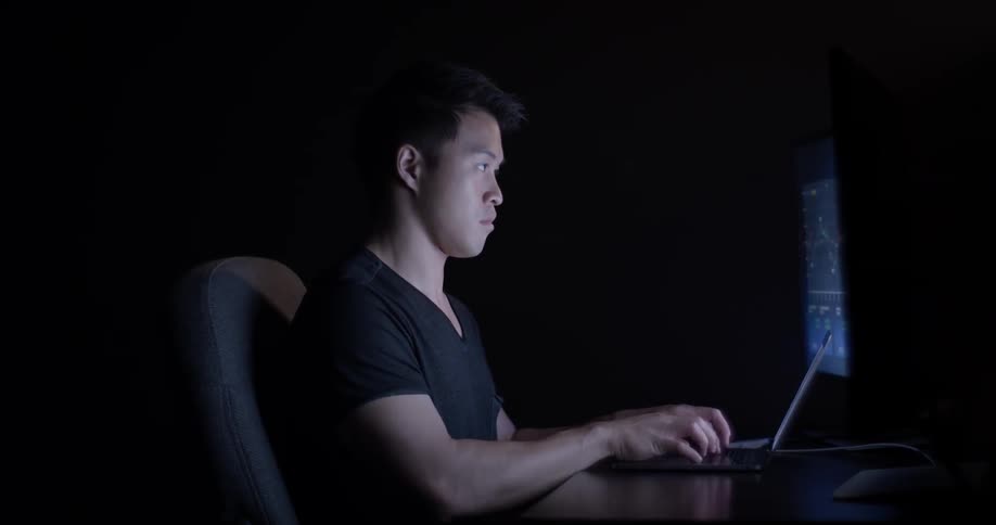 A young man works late into the night at his crowdsourcing job