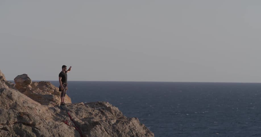 Man Climbing Wall By The Beach