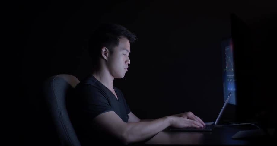 Man Coding On Computer In Dark Room