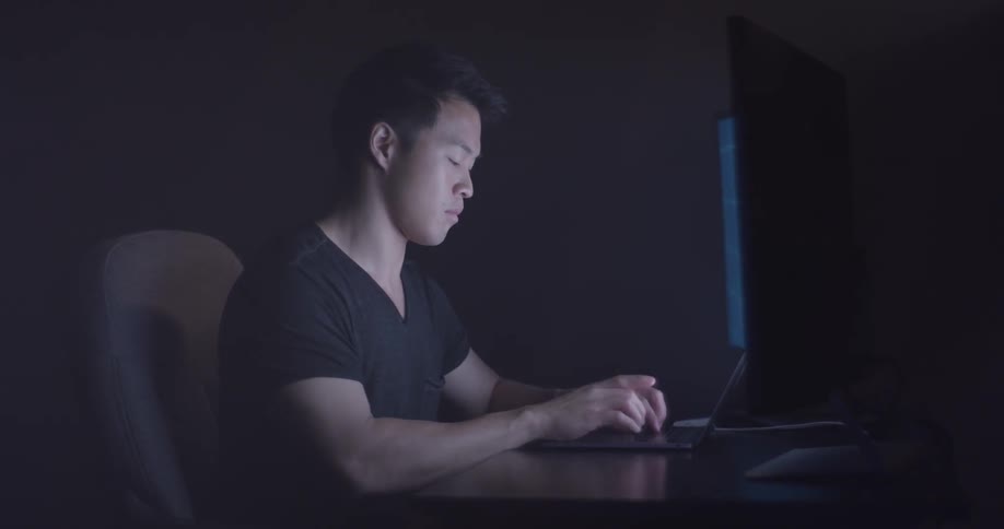 Man Coding On Computer In Dark Room
