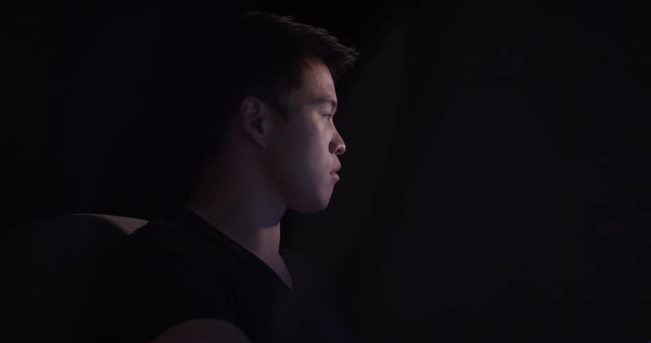 A man is looking back and forth between objects