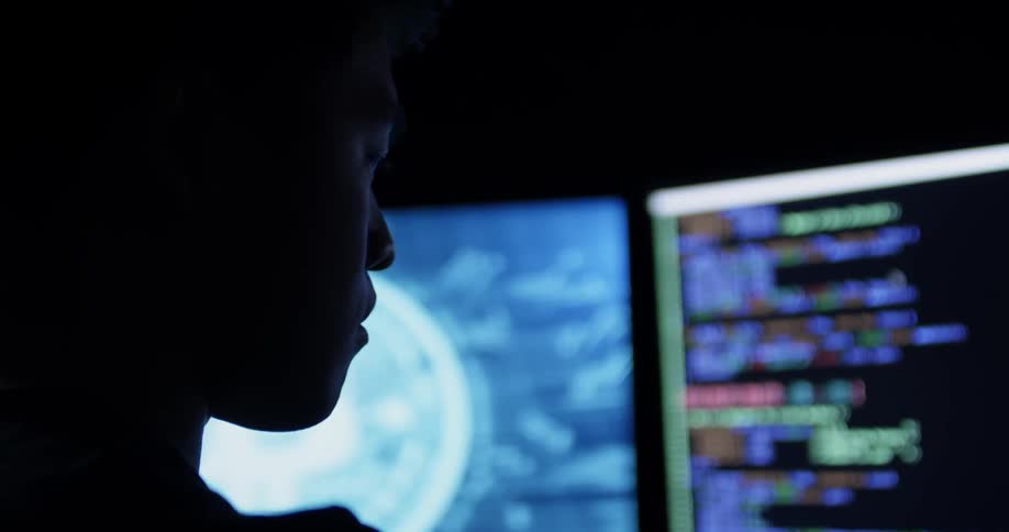 A man staring at computer screens