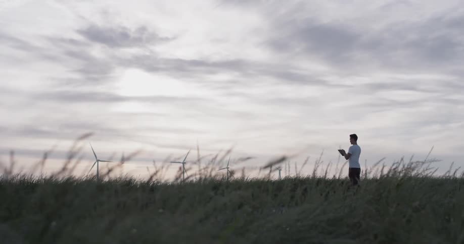 A person using a tablet on a field