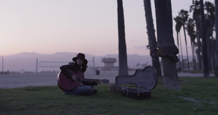 Girl Playing Guitar By The Beach