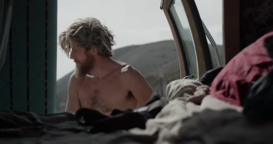 A man gets undressed outside of his van