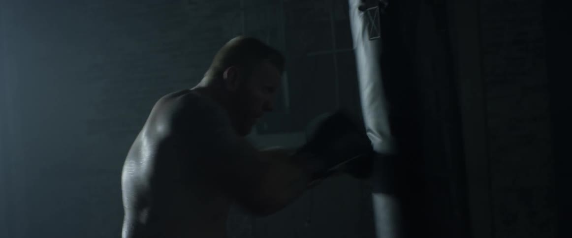A man repeatedly punches a bag