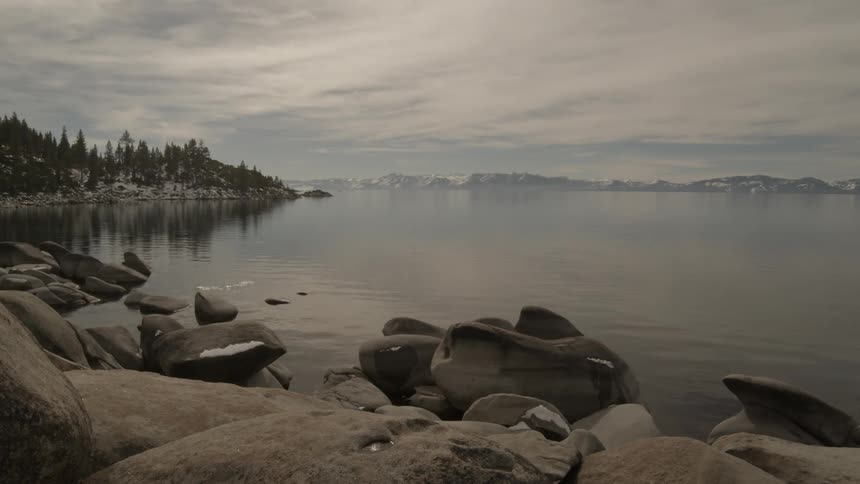 Body of water with mountains and trees in the background