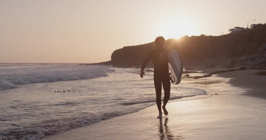 A man walking around at the beach