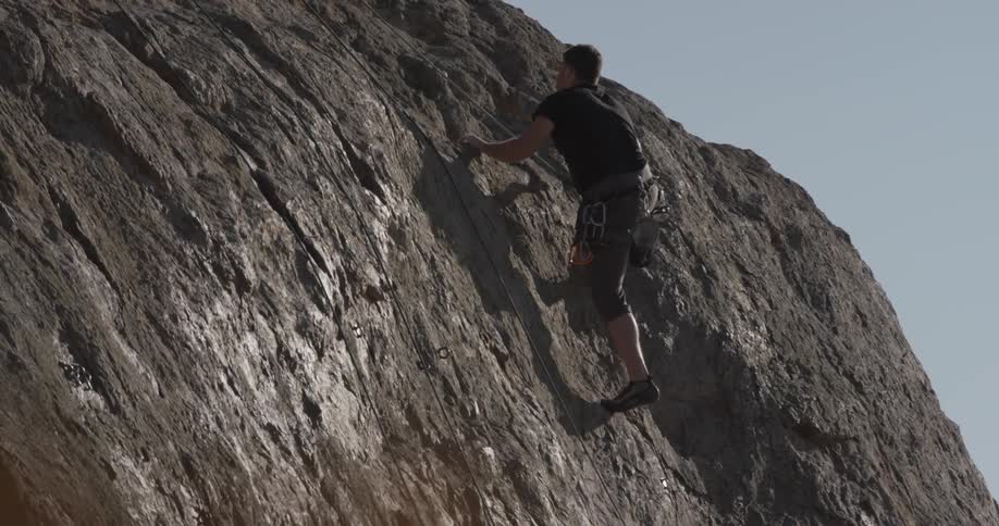 A man climbing up a rock wall