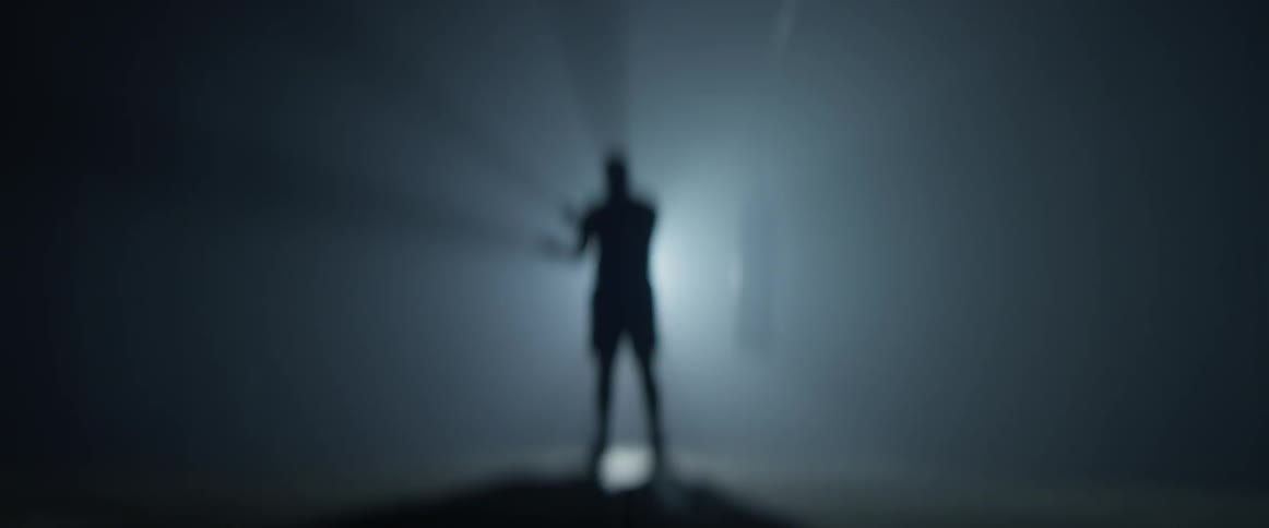 Silhouette of man in dark room jump-roping