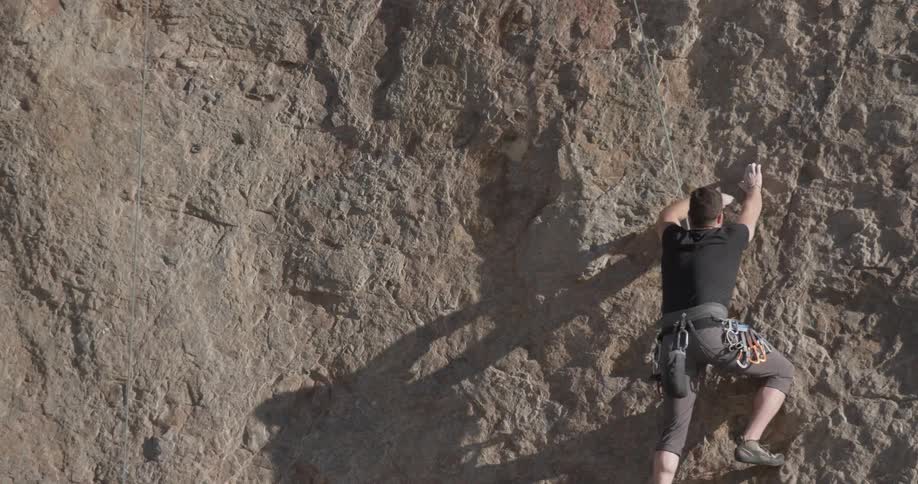 A man is rock climbing outdoors