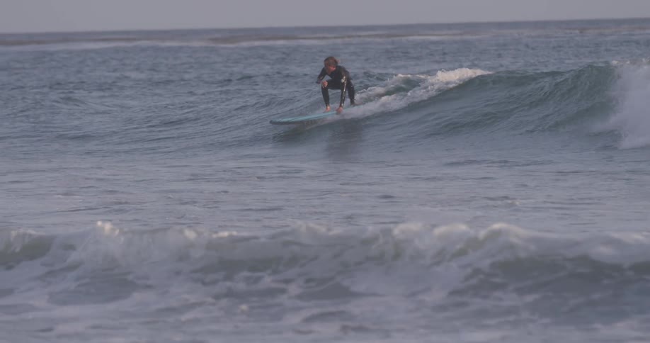 Surfer catches wave in the afternoon