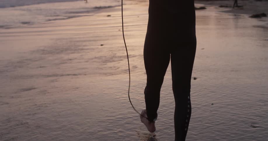 A man is outside walking on the beach
