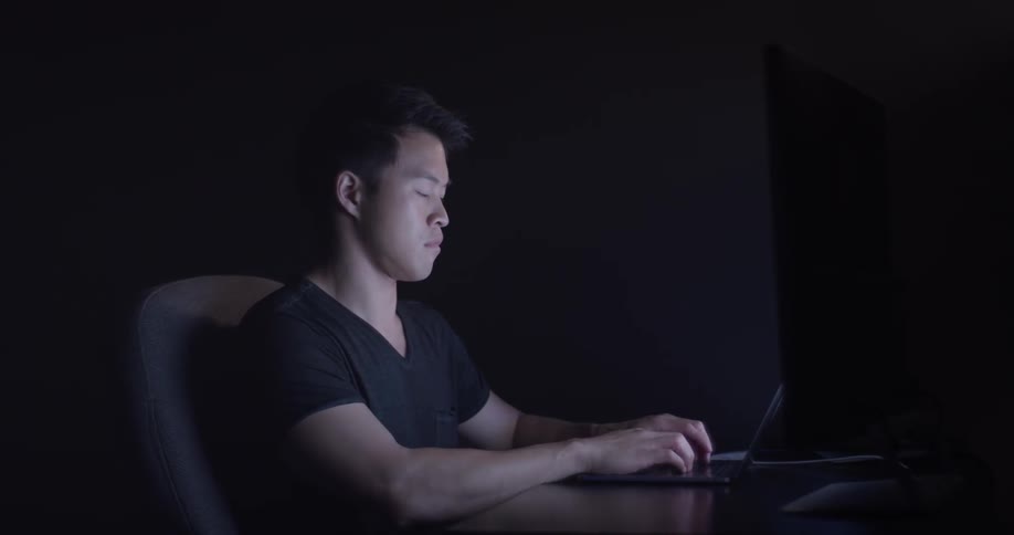 Man Coding On Computer In Dark Room