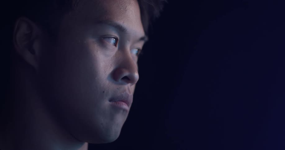 Man sits looking side to side