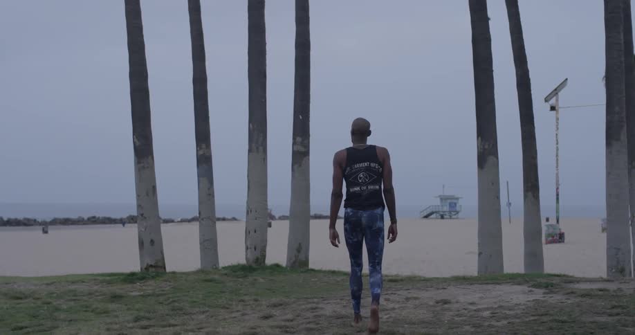 A man walking up to the beach