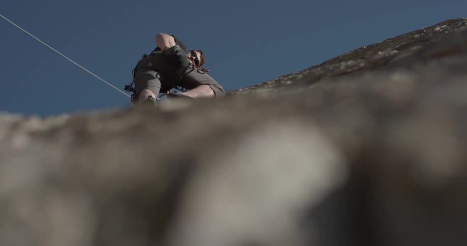 Man Climbing Wall By The Beach
