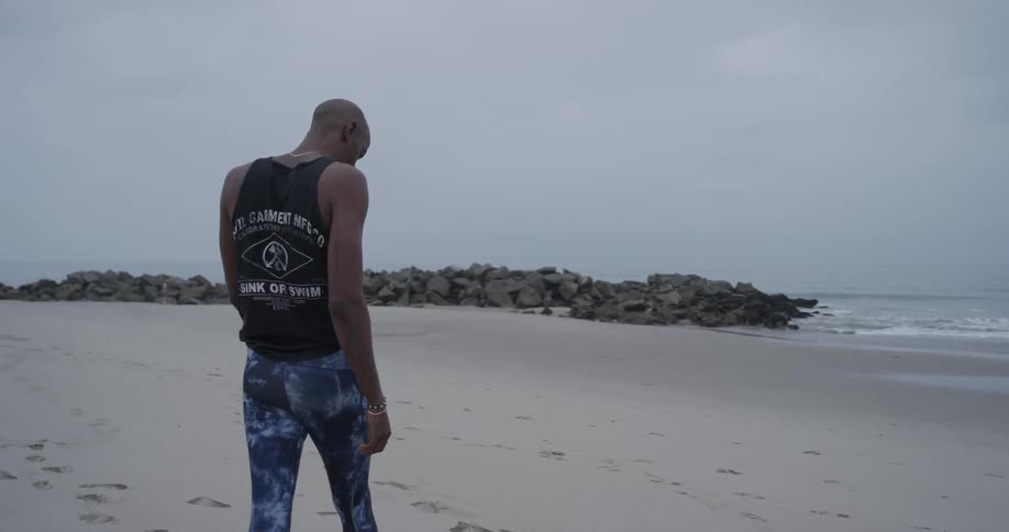 A man walking down to the coast