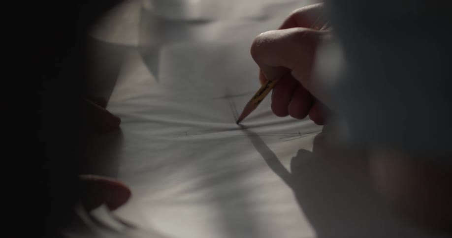 A person is writing on a piece of paper