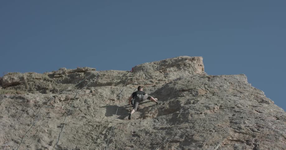 Man climbs rock face