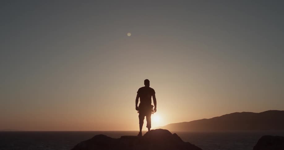 Man Climbing Wall By The Beach