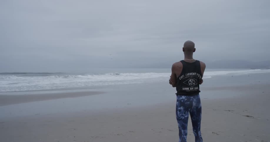 Man Meditating Outside By The Beach