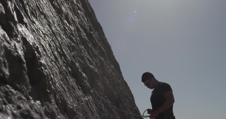 Man climbs rock face