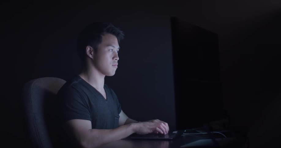 Man Coding On Computer In Dark Room