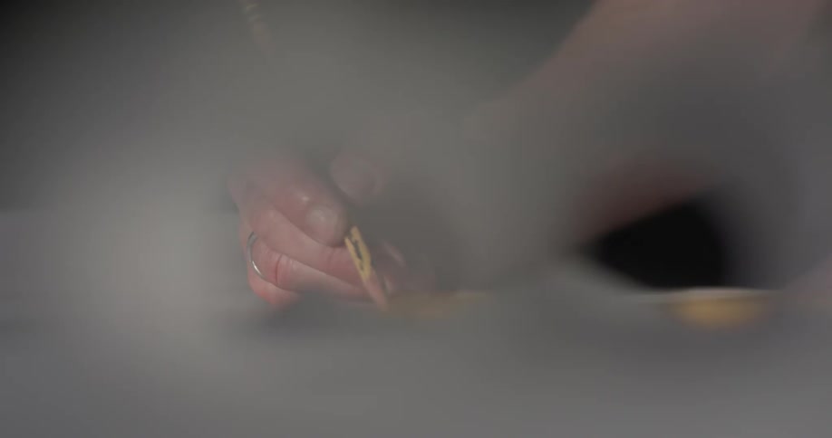 A person sketching in a book using a pencil