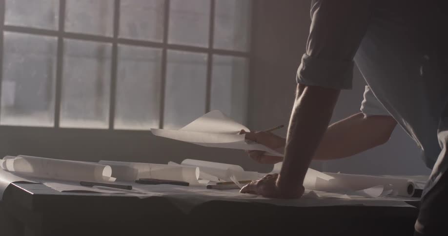 Someone is looking at papers on a table