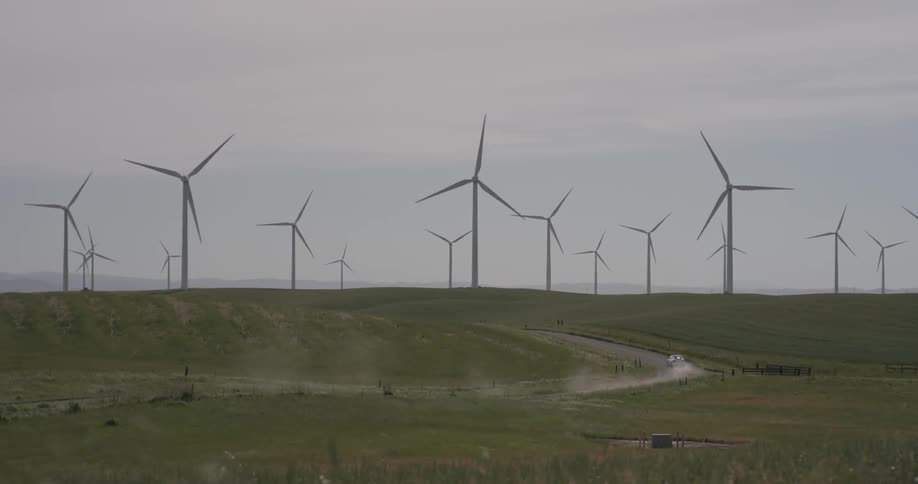 A lot of windmills rotating in slow motion on a cloudy day