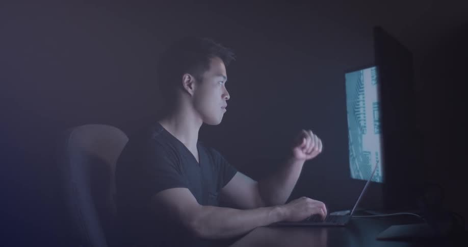 Man Coding On Computer In Dark Room