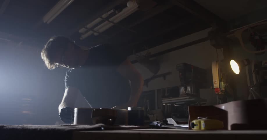 Carpenter Making Guitar In Workshop