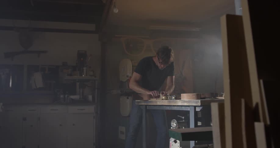 Carpenter Making Guitar In Workshop