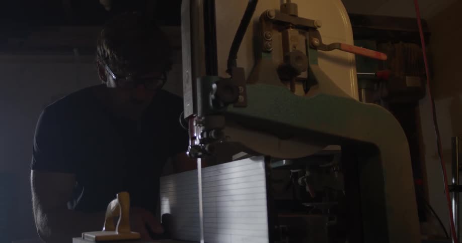 Carpenter Making Guitar In Workshop