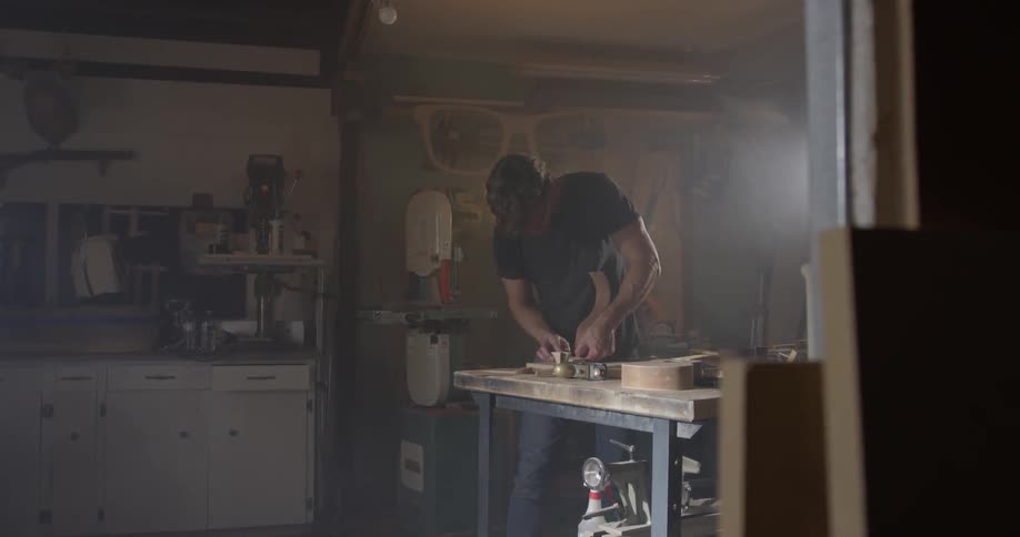 Man works with tools at workbench